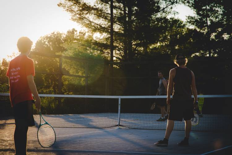 Friends playing tennis on a court